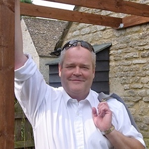 Managing director Adrian Valentine, leaning against a pergola post